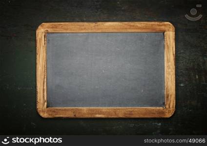 Blank chalkboard for your text. Top view over wooden table with copy space