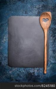 Blank chalkboard with cooking spoon on rustic background, top view. Restaurant or cafe menu. Template design for recipes or ingredients shopping list.