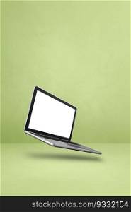 Blank computer laptop floating over a green background. 3D isolated illustration. Vertical template. Floating computer laptop isolated on green. Vertical background