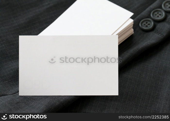 Blank corporate identity package business card with dark grey suit background.