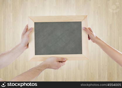 Blank frame. Close up of human hands holding blank frame