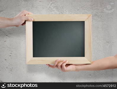 Blank frame. Close up of human hands holding blank frame