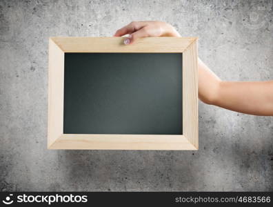 Blank frame. Close up of human hands holding blank frame