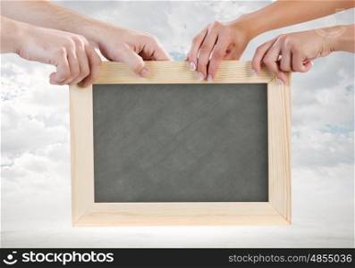 Blank frame. Close up of human hands holding blank frame