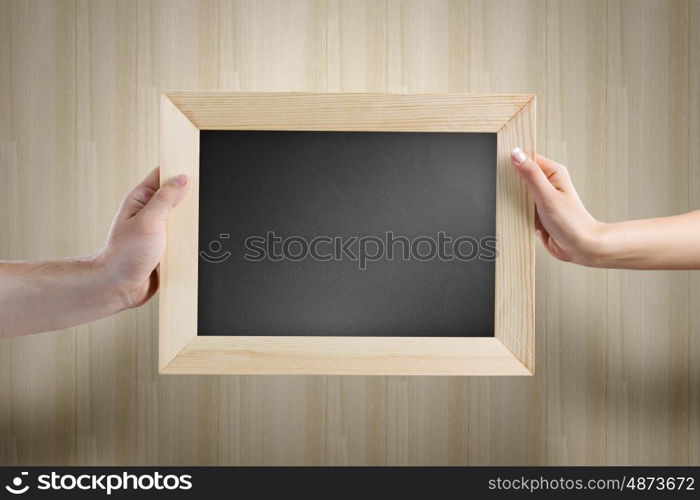 Blank frame. Close up of human hands holding blank frame