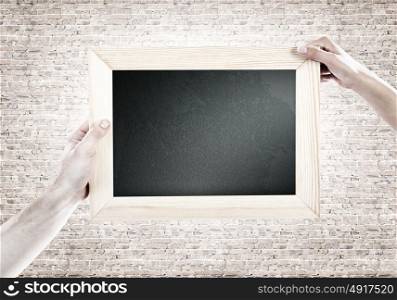 Blank frame. Close up of human hands holding blank frame