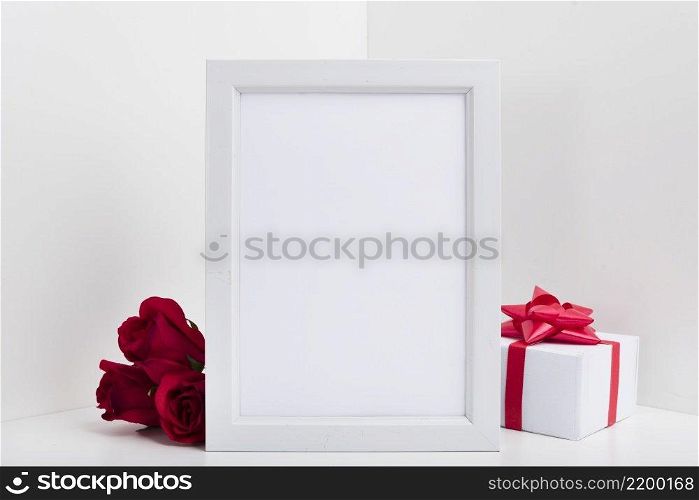 blank frame with gift box red roses