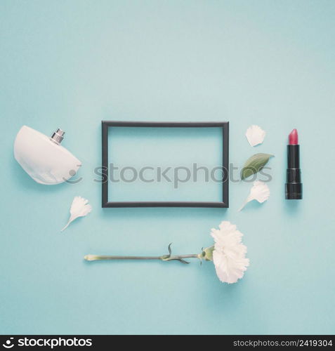 blank frame with lipstick flower table