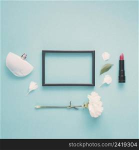 blank frame with lipstick flower table