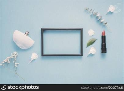 blank frame with lipstick plants table