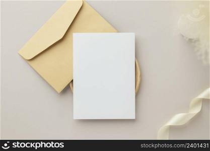 Blank greeting card invitation Mockup 5x7 on envelope with dry flowers and ribbon on paper background, flat lay, mockup
