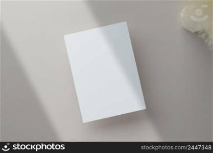 Blank greeting card invitation Mockup 5x7 on envelope with dry flowers and ribbon on paper background, flat lay, mockup
