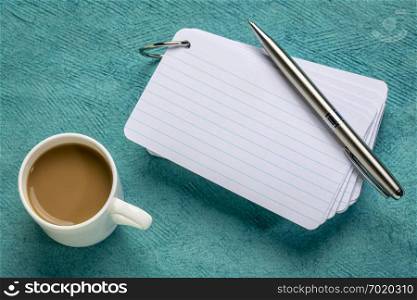 blank index cards with a cup of coffee and a pen against textured paper