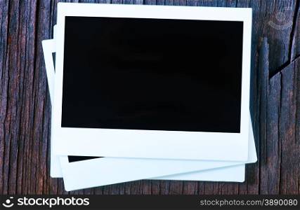 Blank instant photo frames on old wooden background