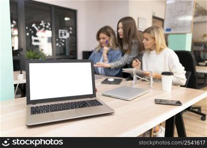 blank laptop coworkers