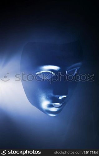 Blank mask in blue hazy light. Short depth of field.