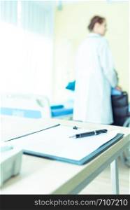Blank medical clipboard healthcare with doctor and patient for blurred background.