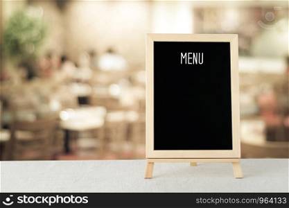 Blank menu board over blur cafe background, food and drink concept