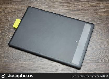 Blank modern digital tablet with papers and pen on a wooden desk. Top view. High quality detailed graphic collage.. Graphic tablet on a white background.