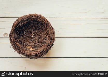 Blank nest on wood background with space