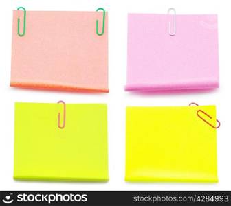 Blank note paper and red paper-clip isolated on white