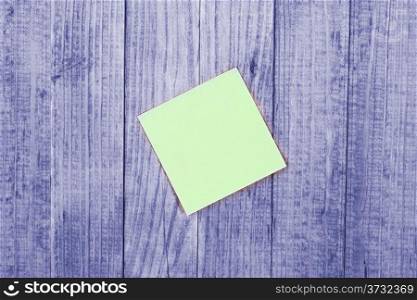 Blank note, paper stick, poster on wood background.