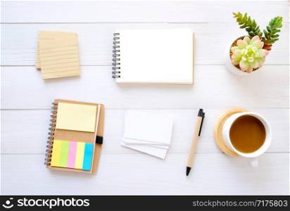 Blank note papers, business card, pen and coffee on white wood table background, with copy space for text, top view