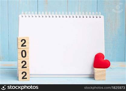 blank notebook and 2022 cubes with red heart shape decoration on blue wooden table background. New Year NewYou, Goal, Resolution, health, Love and Happy Valentine&rsquo;s day concept