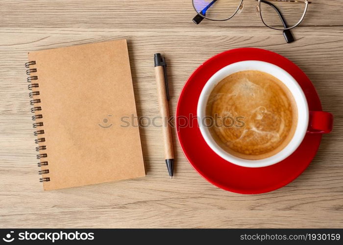 blank notebook and coffee cup on wood table. Motivation, Resolution, To do list, Strategy and Plan concept