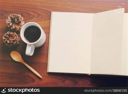 Blank notebook and coffee with retro filter effect