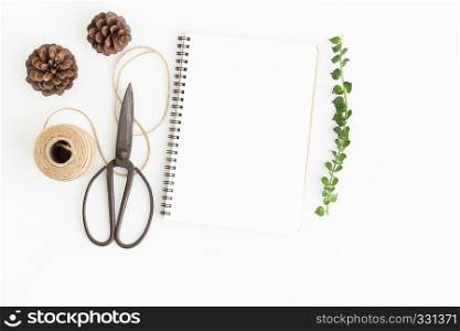 Blank notebook and scissors on white background, Top view image of white notebook and empty space for text