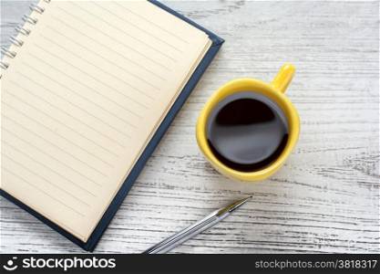 blank notebook coffee cup and notebook on wooden background