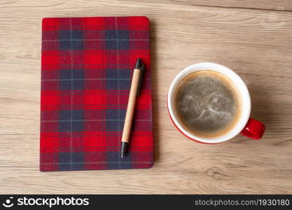 Blank notebook, coffee cup and pen on wood table. Happy New Year, Goals, Resolution, To do list, Strategy and Plan concept