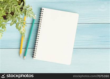 Blank notebook with and pencil on blue background,Flat lay photo of notebook for your message