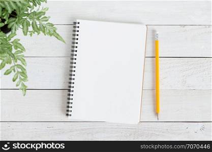 Blank notebook with and pencil on white wood,Flat lay photo of notebook for your message