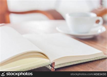 Blank notebook with coffee cup, stock photo