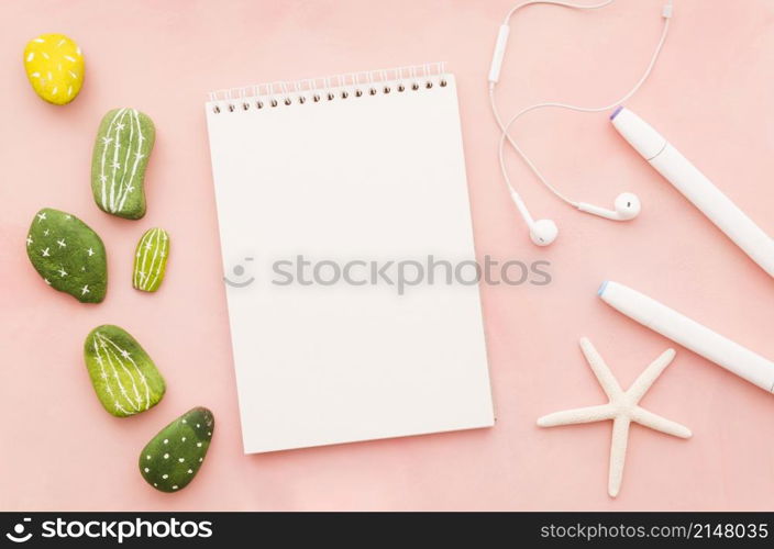 blank notebook with earphones sea star