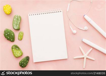 blank notebook with earphones sea star