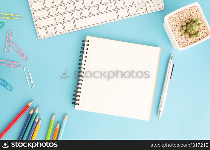 Blank notebook with keyboard and pen on blue background,Flat lay photo of notebook for your message