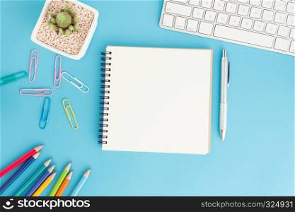Blank notebook with keyboard and pen on blue background,Flat lay photo of notebook for your message