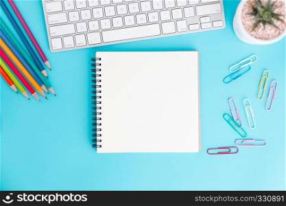 Blank notebook with keyboard and pencil on blue background,Flat lay photo of notebook for your message