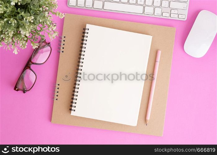 Blank notebook with keyboard and pencil on pink background, Flat lay photo of notebook for your message