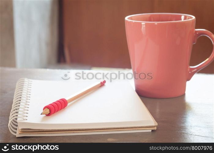 Blank notebook with pencil on grey background, business concept