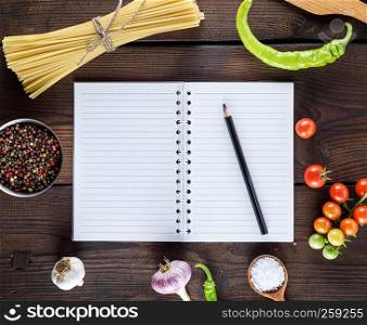 blank notebook with white sheets, raw long paste and ingredients for cooking, top view