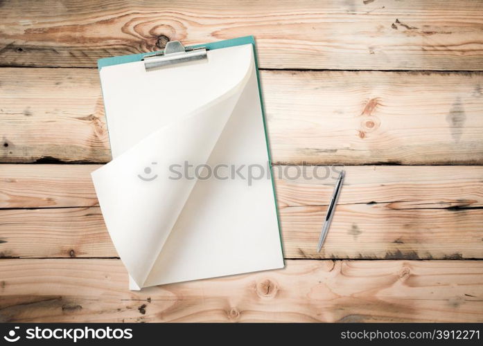 Blank notepad with pen on wood table, free space for text