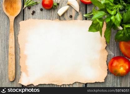 Blank old aged paper with copy space for recipe with ingredients and wooden spoon on the table. Italian recipe
