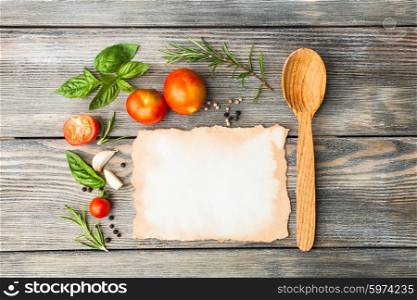Blank old aged paper with copy space for recipe with ingredients and wooden spoon on the table. The Italian recipe
