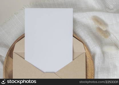 Blank paper cards, Blank greeting card invitation Mockup with craft envelope, Dried Bunny Tail grass on desk background, Minimal table workplace composition, flat lay, mockup