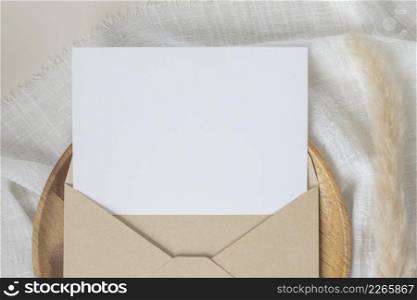 Blank paper cards, Blank greeting card invitation Mockup with craft envelope, Dried Bunny Tail grass on desk background, Minimal table workplace composition, flat lay, mockup