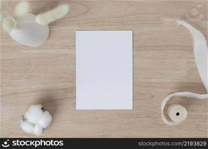 Blank paper cards, Blank greeting card invitation Mockup with Dried Bunny Tail grass in vase on a wood table, wood desk background, Minimal wood table workplace composition, flat lay, mockup